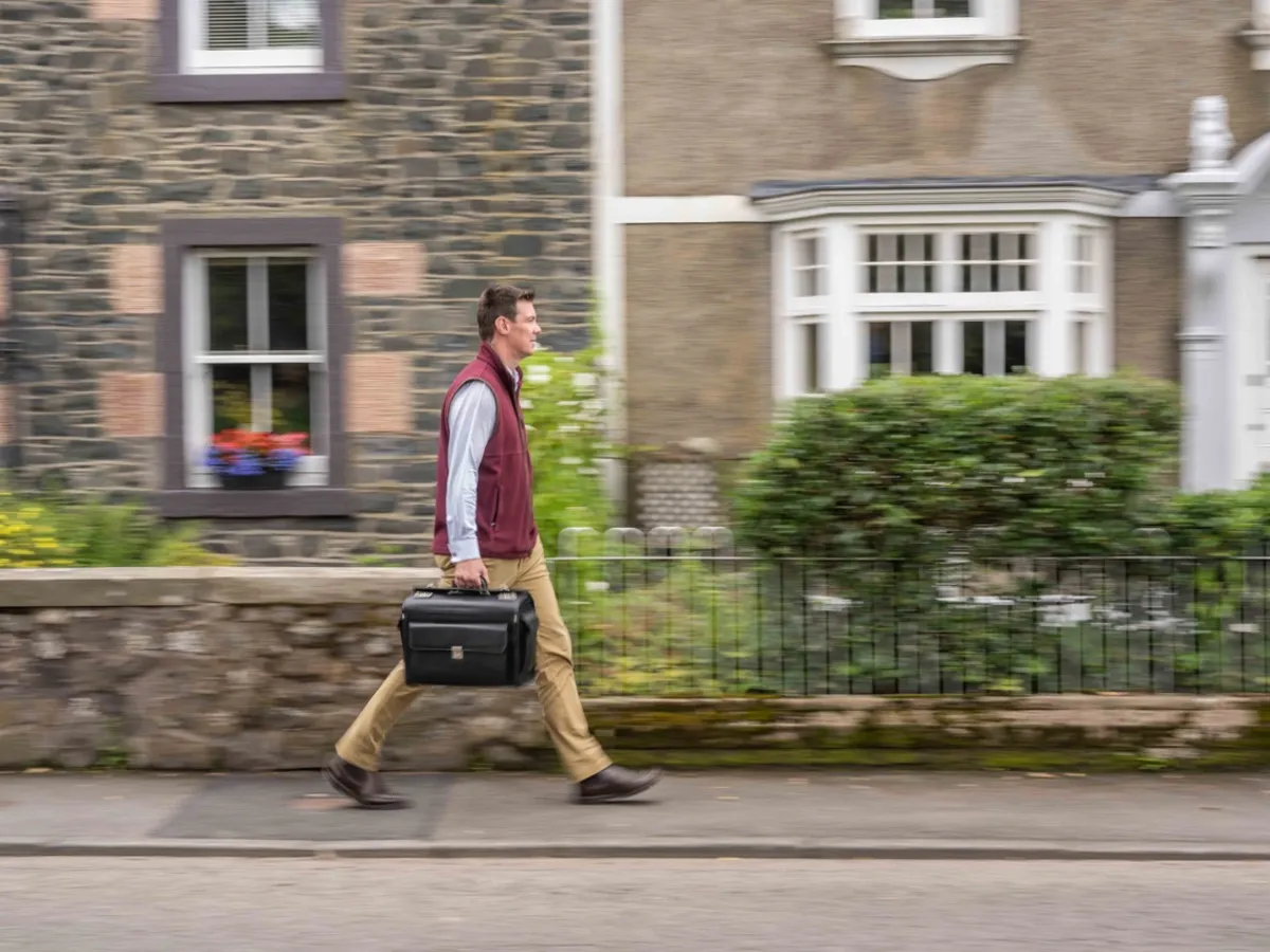 Doctor walking to a home visit