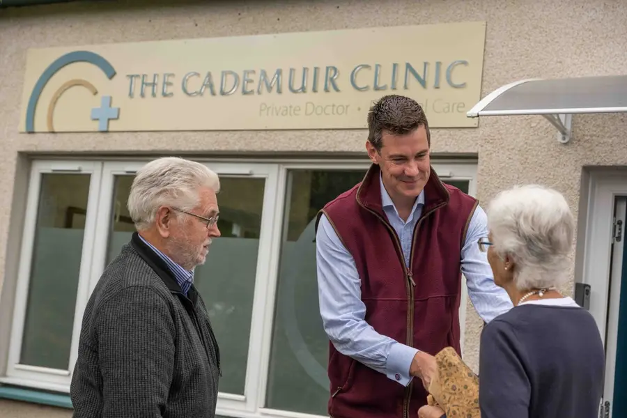 Doctor greeting patients outside The Cademuir Clinic