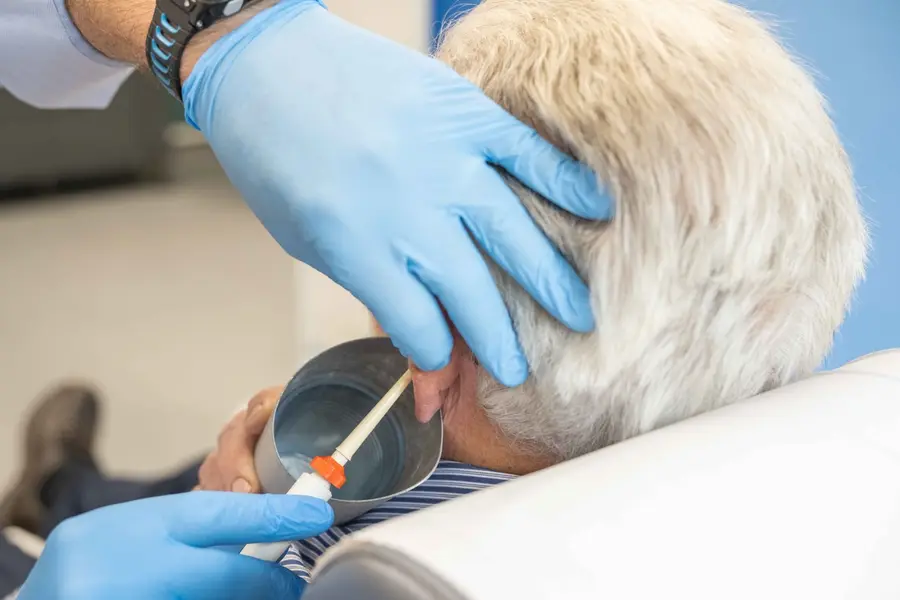 Ear treatment being provided in a clinical setting