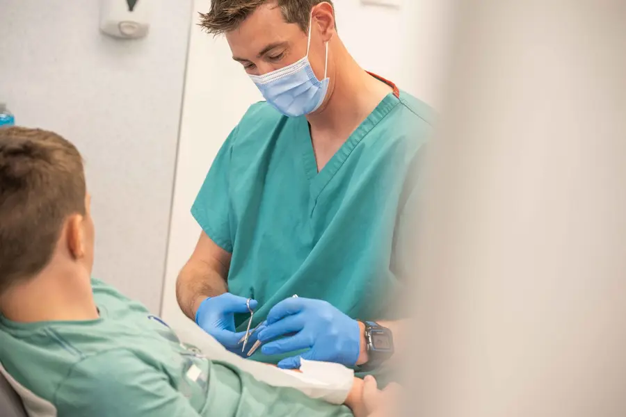 Clinician wearing gloves during minor treatment