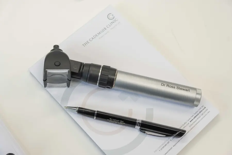 Medical paperwork and diagnostic instrument at The Cademuir Clinic